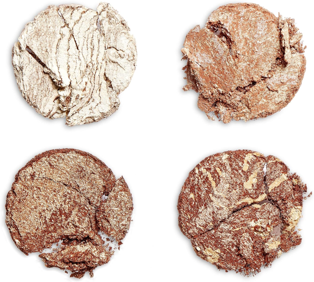 Four smashed highlighter powders in shades of gold, bronze, and beige on a white background.