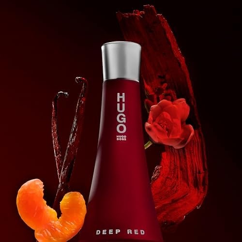 Hugo Boss Deep Red perfume bottle with orange, vanilla, and rose accents on a dark background.
